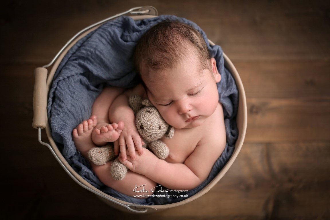 newborn baby boy with his teddy bear in blue - Kate Eden Photography - Milton Keynes